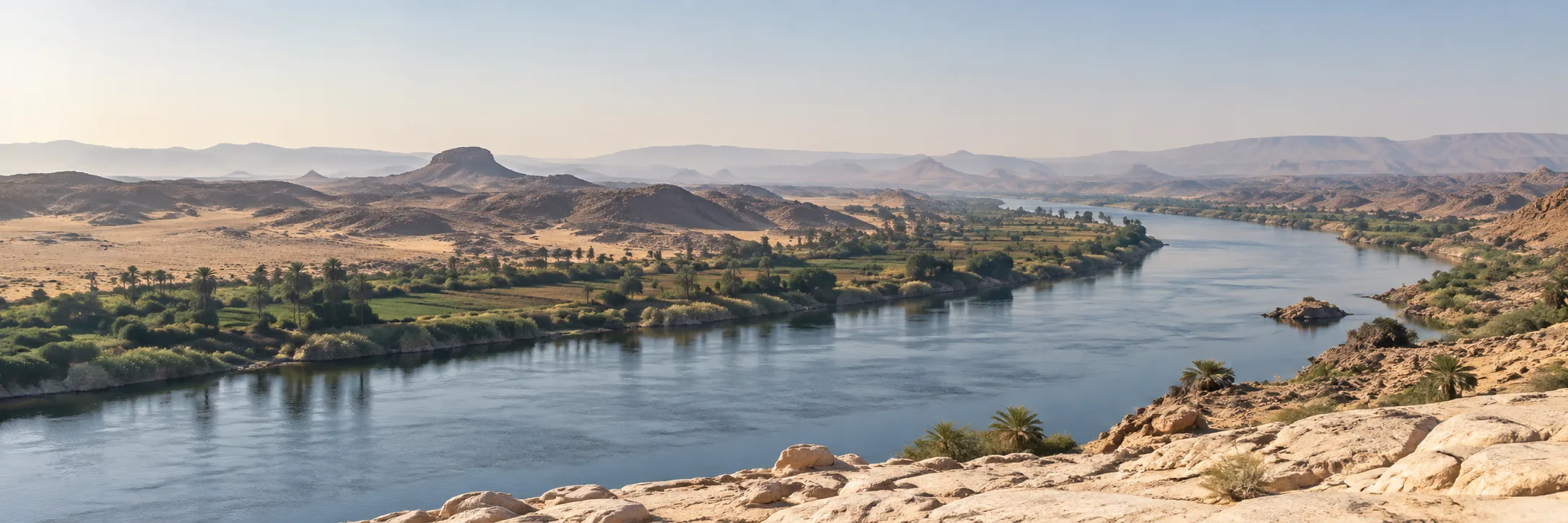 Nile-inspired landscape with a river between rocky desert and green banks.